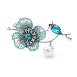 Брошка пташка на гілці з квіткою